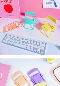 Macro shot of colorful mini chair phone stands showing foldable design and macaron colors