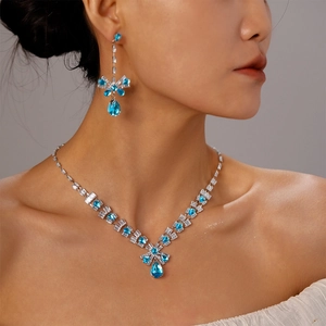 Elegant silver jewelry set featuring blue teardrop zircon necklace and matching earrings