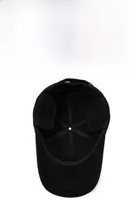 Detailed interior of black winter baseball cap showing thick fleece lining and ear flaps