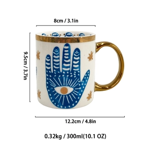 Detailed view of white ceramic Hamsa eye mug showing size dimensions and gold handle