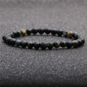 Detailed close-up of tiger eye and lava stone beads with natural texture and cat-eye effect