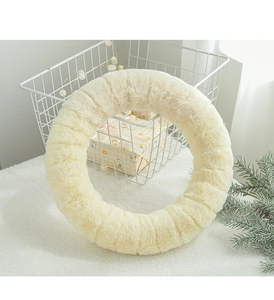 Detail of plush beige Christmas reindeer wreath with soft wool texture for DIY decor