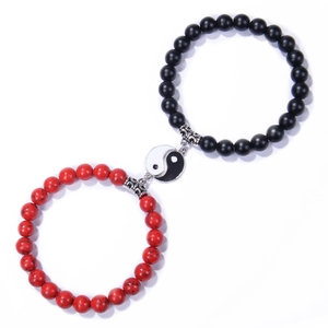 Macro detail of Yin Yang couple beaded bracelets with matte black and white marble stone beads