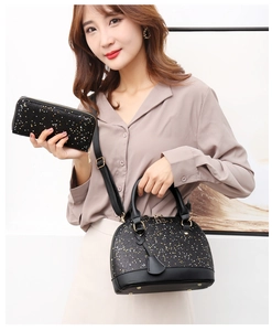 Detail of black glitter shell handbag and matching wallet with sequins and shoulder strap