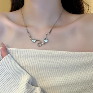 Detailed view of silver wave pendant necklace with two radiant blue opal stones