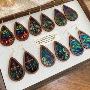 Ethnic teardrop earrings collection in wooden frames on elegant display tray