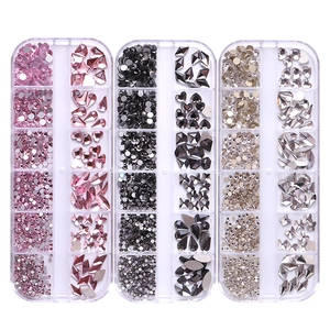 Three boxes of assorted glass rhinestones for nail art in pink, black, and clear colors