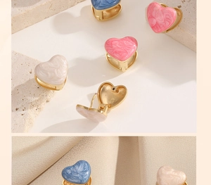 Detail of heart-shaped stainless steel earrings with colorful marble texture enamel finish