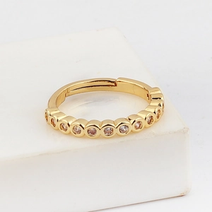 Detailed close-up of a gold-plated adjustable ring featuring circular zircon settings