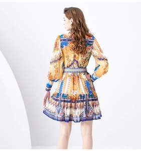 Detail view of baroque floral print dress showing vintage patterns and lantern sleeves