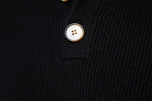 Close-up of black knit sweater with detailed button placket and premium fabric texture