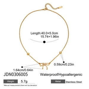 Macro shot showing dimensions and features of a 18K gold butterfly necklace in detail