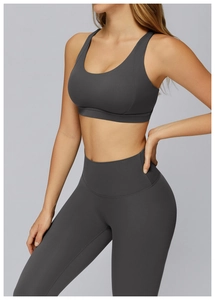Detail of high-stretch seamless charcoal grey yoga set with cutout back on model