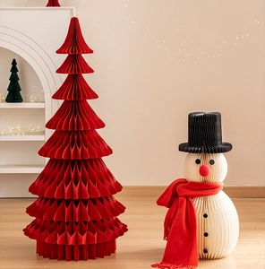 Detail of red honeycomb paper Christmas tree and white snowman with scarf decoration