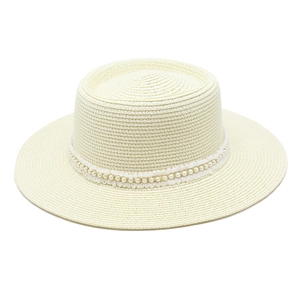 Detailed texture of off-white woven straw sun hat with elegant pearl lace band