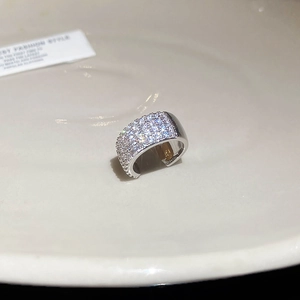 Macro shot of silver plated C-shaped ear cuff with pave set cubic zirconia stones