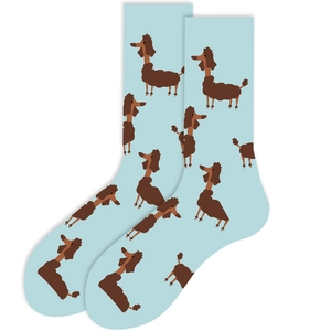 Detail of light blue crew socks featuring brown cartoon poodle patterns on soft fabric