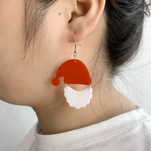 Boucles d'oreilles Père Noël rétro avec bonnet rouge portées sur l'oreille