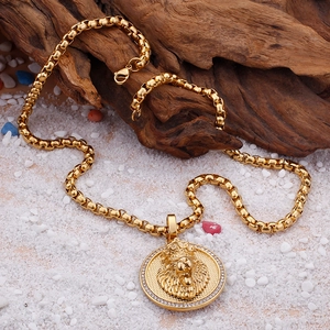 Detailed close-up of a gold-plated lion head pendant with sparkling cubic zirconia accents