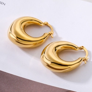 Polished 18K gold plated wide chunky geometric hoop earrings on minimalist background