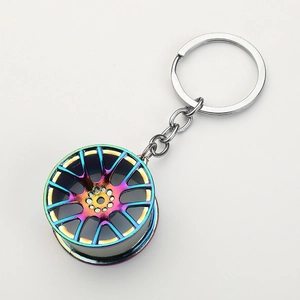 Detailed close-up of a neo-chrome zinc alloy car wheel rim keychain with a gradient finish