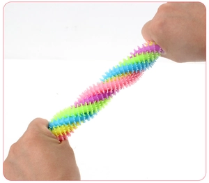 Close-up of stretchy TPR caterpillar toy being pulled to show high elasticity and soft spikes