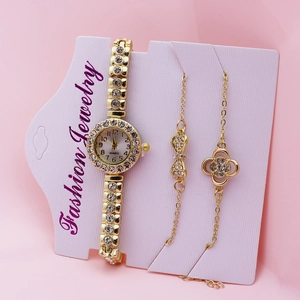 Elegant gold-toned women's rhinestone watch and matching charm bracelets on display card