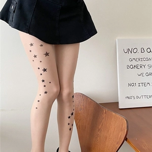 Nude star-print sheer pantyhose for women with trendy black star pattern on model