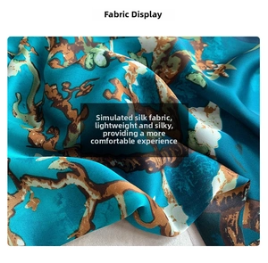 Detail showing the silky texture and elegant floral pattern of the long scarf