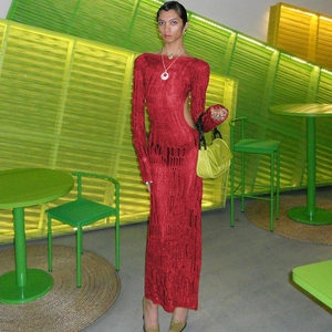 Detail of the backless cutout design on a deep red knitted long-sleeved dress