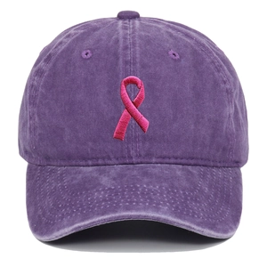 Detailed view of pink ribbon embroidery on washed purple cotton baseball cap