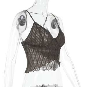 Detailed macro shot of dark brown lace fabric and intricate floral patterns on a crop top