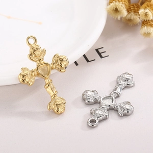 Gold and silver stainless steel cross pendants with rose relief and heart detail