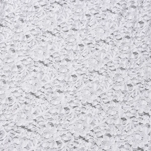 Macro shot of white floral lace fabric showing intricate patterns and premium texture