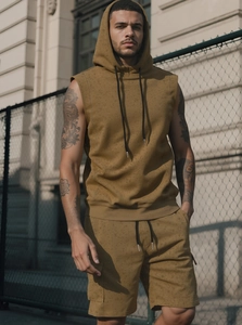 Detail of premium cotton fabric texture on men's sleeveless mustard hoodie and shorts set