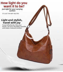 Detailed close-up of brown faux sheepskin crossbody bag with multiple zippers and adjustable strap