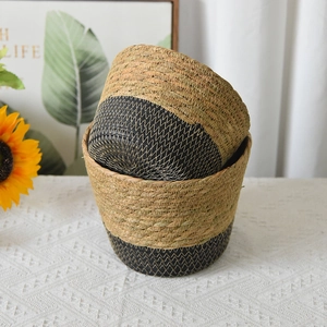 Detail of natural seagrass woven baskets in natural and black dual-tone weave design
