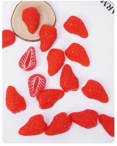 Detailed macro shot of realistic strawberry resin miniatures with vivid texture and cross-sections