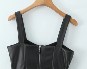 Detailed view of the black PU leather camisole featuring a metallic front zipper and wide straps