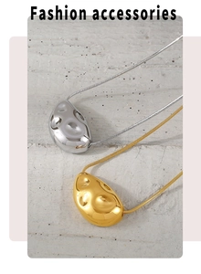 Close-up of molten lava texture pendants in gold and silver on snake chains