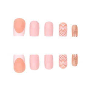 Pink press-on nails set with glitter, heart patterns, and classic French tips on white back