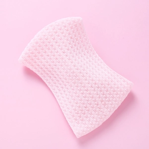Close-up of pink knitted baby headband showing the breathable mesh texture and fabric detail