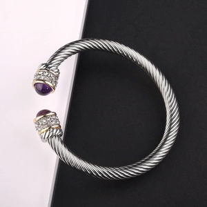 Silver cable cuff bracelet with purple natural stone and gold accents on a duo background