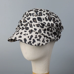 Detail view of leopard print baker boy hat with crisp brim and textured cotton fabric