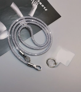 Close-up of sparkling silver rhinestone phone lanyard with metal clasps and clear pad