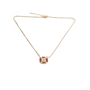Gold pendant necklace with red gemstones and micro-pave zircon on a classic curb chain
