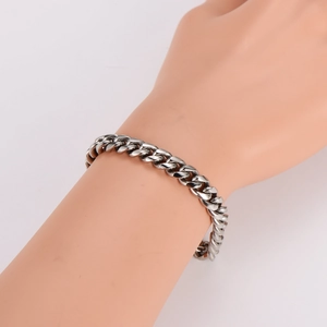 Mens thick silver stainless steel Cuban link bracelet worn on a mannequin hand