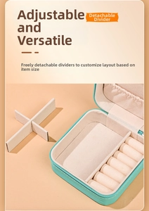 Detail of mint green leather jewelry box with removable dividers and soft velvet lining