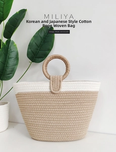 Close-up of the woven cotton rope tote bag with a circular handle and minimalist two-tone design
