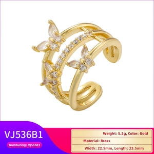 Detailed view of gold plated brass ring with triple bands and zircon butterflies